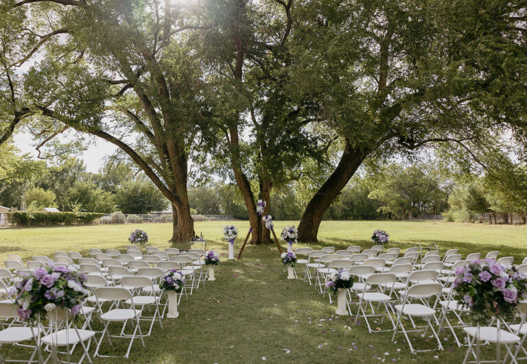 red horse bnb outdoor ceremony trees purple white florals aisle elise almendarez 768x531