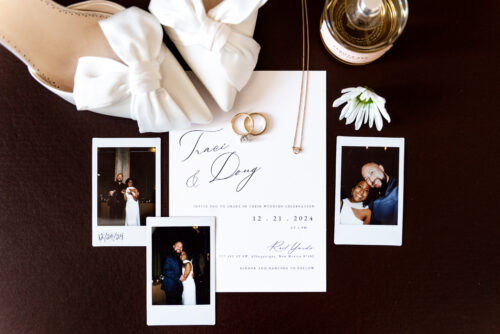 Flat lay of invitations and couple photos