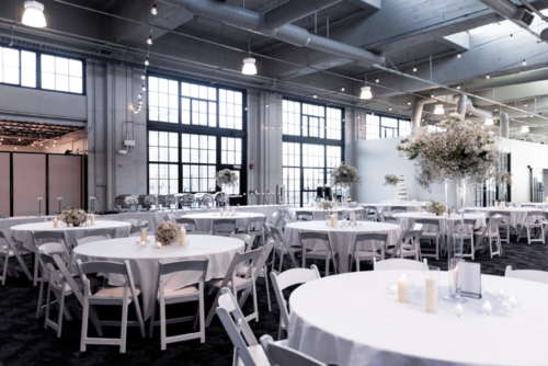 Image of set tables inside industrial building
