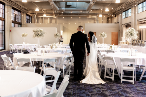Couple walking through tables in an industrial building